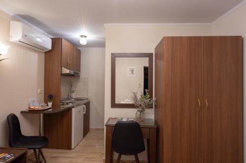 a small kitchen with a table and chairs in a room at Voulas Traditional House Meteora 3 in Kalabaka