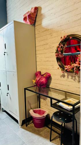 a room with a table and a mirror on a wall at Iconic Athens Hostel in Athens