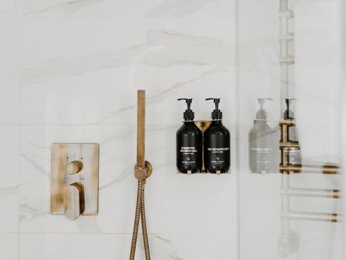 a group of bottles on a wall in a bathroom at Grand Hotel Lviv Casino & Spa in Lviv