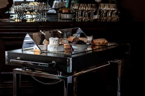 a tray of bread and pastries on a table at Van der Valk Hotel Kasteel Terworm in Heerlen