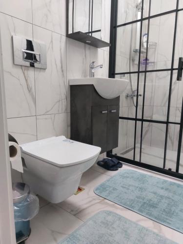 een badkamer met een wit toilet en een wastafel bij Bahcelievler Memorial Hospital Suit in Istanbul