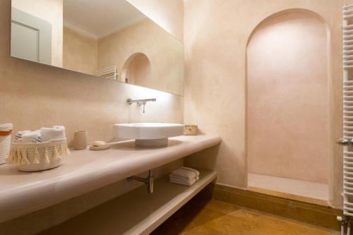 a bathroom with a sink and a mirror at Villa Karma in Spetses