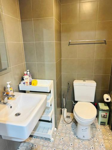 a bathroom with a white toilet and a sink at HuaHin La Casita condo Quiet, bright room with nice view Netflix vip #2 in Hua Hin