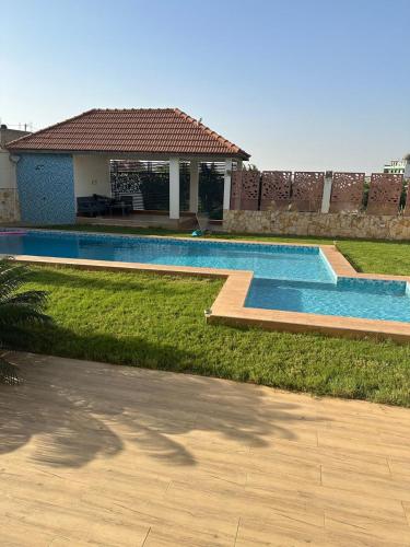 a swimming pool in the yard of a house at Villa Eve in Rufisque