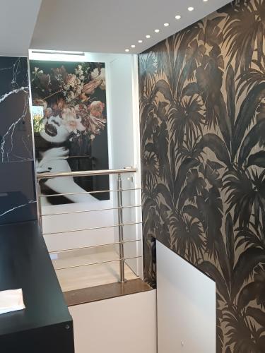 a hallway with a black and brown wallpaper at Blumoon boutique in Andria