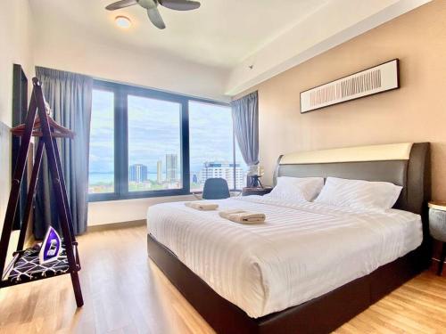 a bedroom with a large bed and a large window at Tropicana 218 Macalister #Seaview #Modern Retro #Infinity Pool #Georgetown #7pax #3BR 2bath #1King 2Queen 1Single #Quality well maintained #Private host in George Town