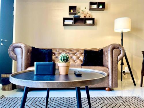 a living room with a couch and a table at Tropicana 218 Macalister #Seaview #Modern Retro #Infinity Pool #Georgetown #7pax #3BR 2bath #1King 2Queen 1Single #Quality well maintained #Private host in George Town