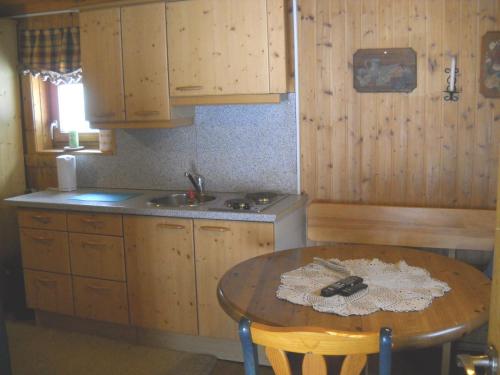 a kitchen with a table and a sink and a counter at Chalet Hansl in Vordernberg