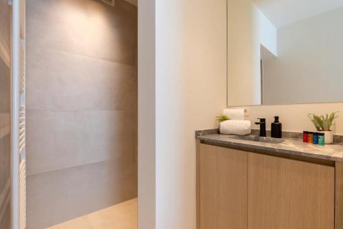 a bathroom with a sink and a mirror at Huswell - Central located apartment with parking in Knokke in Knokke-Heist