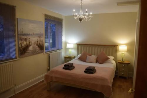 a bedroom with a bed with two towels on it at Spacious County Durham Home in Durham