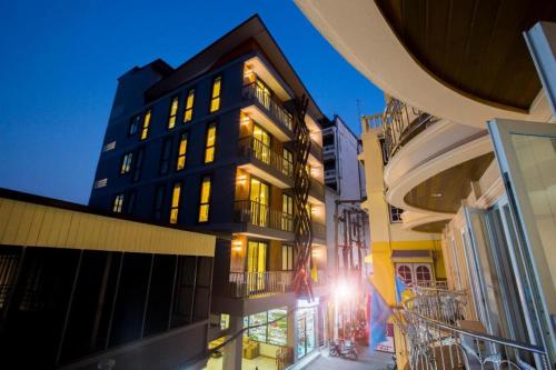 a building with lights on in a city at night at P.72 Hotel in Pattaya South