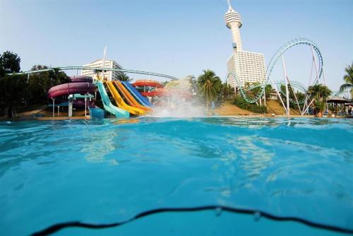 a water slide in a water park with a roller coaster at P.72 Hotel in Pattaya South