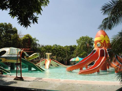 a water park with a slide in the water at DJ Paradise Hotel in Tikay