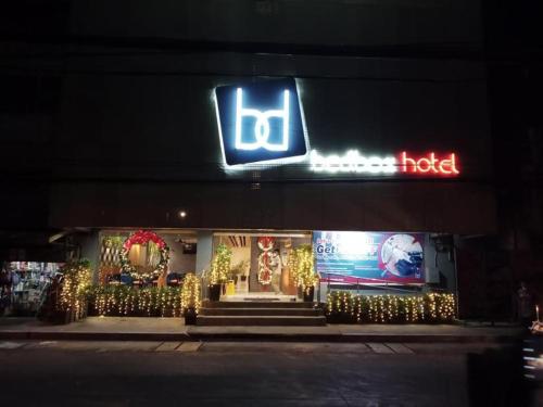 a store front with a sign and christmas lights at Bedbox Hotel Dagupan in Dagupan