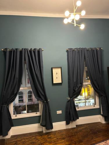 a room with black curtains and a window at Patrick Street Townhouse in Cork