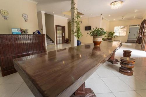 a large wooden table with a vase on top of it at Mekong View Hotel in Phnom Penh