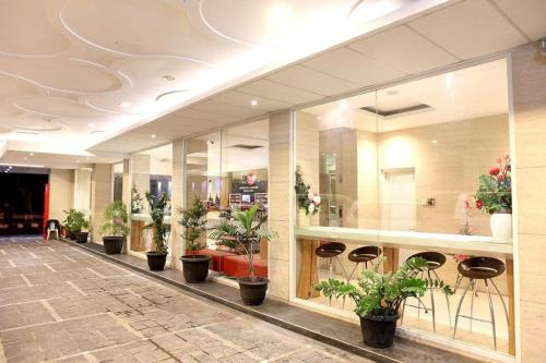 a lobby with a row of potted plants at Citihub Hotel @Jagoan Magelang in Magelang