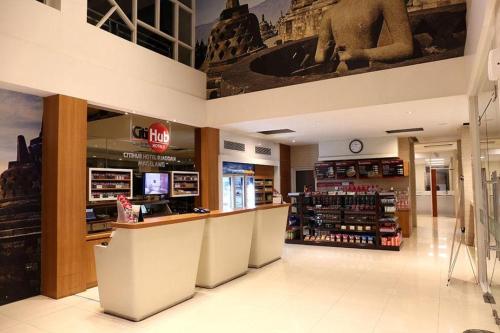 a grocery store with a counter in a store at Citihub Hotel @Jagoan Magelang in Magelang