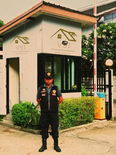 a man is standing in front of a building at V51 Hotel in Nakhon Ratchasima