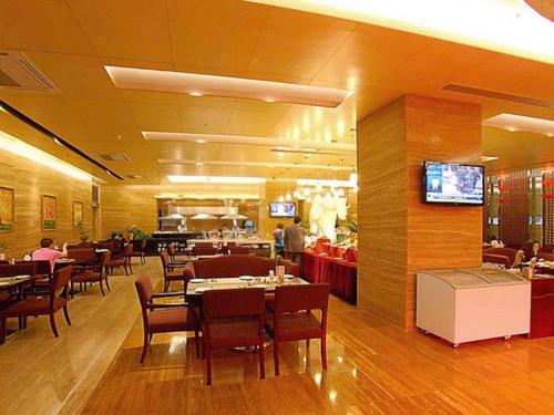 a dining room with tables and chairs and a restaurant at Fuzhou Fuqing Ruixin Hotel in Fuzhou