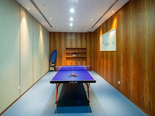 a ping pong table in a room with wooden walls at Xian Elegant Oriental Hotel in Xi'an
