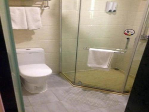 a bathroom with a toilet and a glass shower at 7 Days Premium Suqian Xiang Wang's Hometown Scenic Spot in Suqian