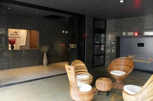 a lobby with chairs and a television in a building at Hwagok Haedamchae in Seoul