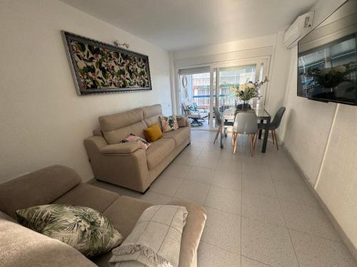 a living room with a couch and a table at Apartamento Muchavista Primera Línea de Playa By El Conserje in El Campello