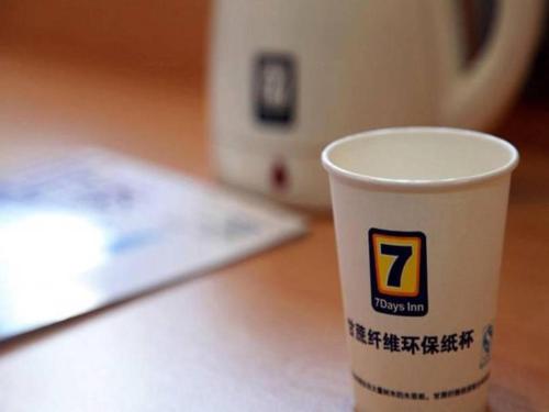a coffee cup sitting on top of a table at 7 Days Inn Beijing South Railway Station in Beijing