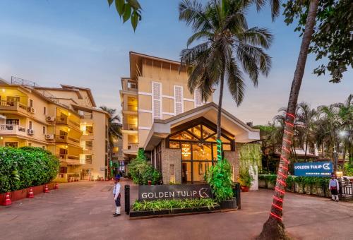 a man standing in front of a building at Golden Tulip Candolim, Goa in Candolim