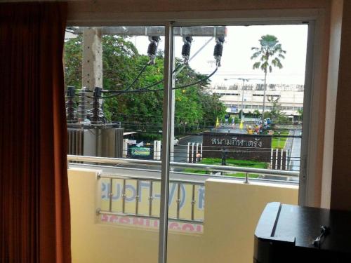 a window in a room with a view of a street at V-House Hotel in Trang