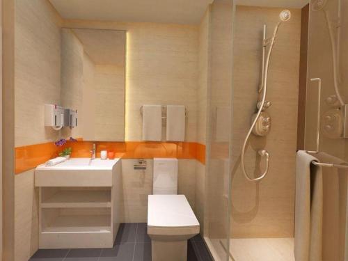 a bathroom with a toilet and a sink and a shower at 7 Days Inn Yingshang Lanxing Building Materials Market in Fuyang