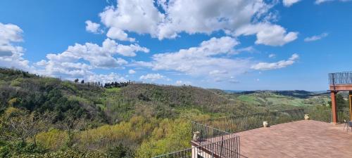 a balcony with a view of a mountain at Colleverde Country House & SPA Urbino in Urbino