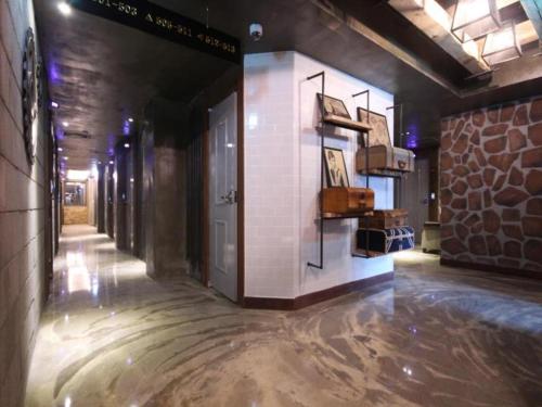 a hallway of a building with a door and a shelf at Gallery Hotel in Daegu