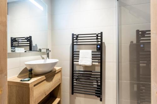 a bathroom with a sink and a shower at Résidence Club MMV Samoens in Samoëns