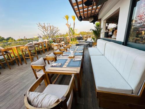 a row of tables and chairs on a patio at Ngon Avatar Hotel in Pleiku