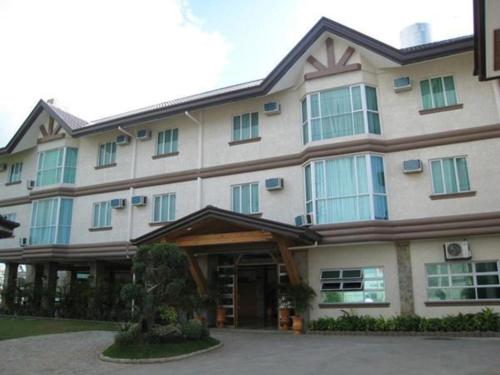 a large building with a building at Chocolate and Berries Hotel in Baliuag
