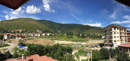 a view of a city with a mountain in the background at Hotel Valley Thimphu in Thimphu