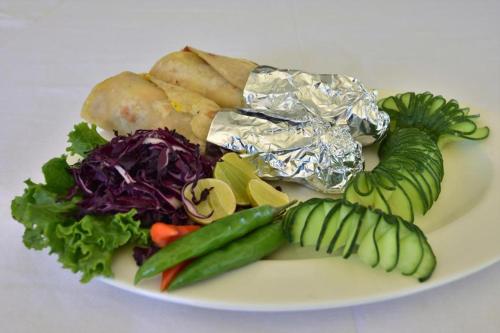 a plate of vegetables on a white plate at Hotel Valley Thimphu in Thimphu