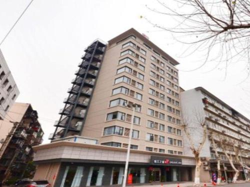a tall building in a city with at Jinjiang Inn Wuhan Zhonghua Road HuangheLou Branch in Wuhan