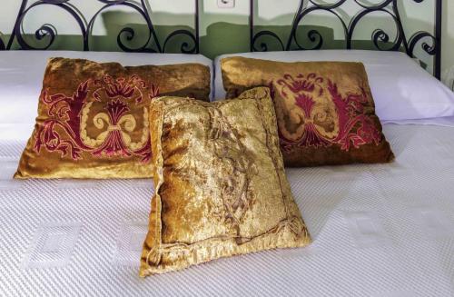 three brown pillows sitting on a bed at Hotel Utopía in Benalup Casas Viejas