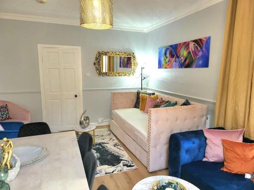 a living room with a couch and a table at 4 Bedrooms Apartment By Sensational Stay Short Lets & Serviced Accommodation in Edinburgh