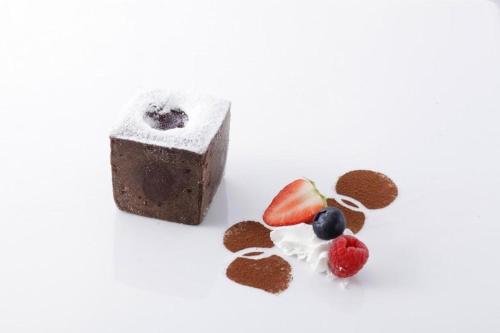 a bar of chocolate and fruit on a white background at Hotel Grand Shinonome in Tsukuba