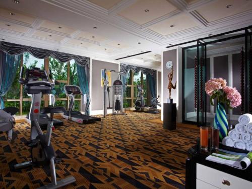 a gym with a treadmill and exercise equipment in a room at Tongxiang Inspirock Hotel in Jiaxing