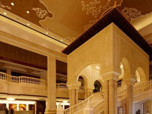 a large building with a staircase in a mall at Tongxiang Inspirock Hotel in Jiaxing