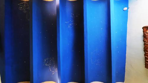 a blue curtain with stars on it at Hotel Utopía in Benalup Casas Viejas