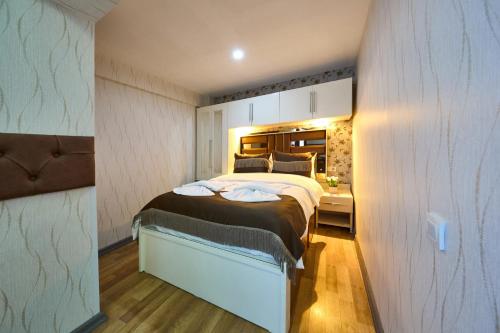 a bedroom with a large bed in a room at By Aydın Suites in Istanbul
