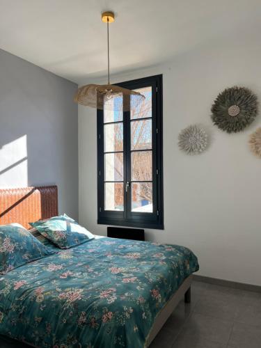 a bedroom with a bed and a window at Quai du Félibre in LʼIsle-sur-la-Sorgue