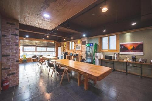 kuchnia z dużym drewnianym stołem i krzesłami w obiekcie B&F Hotel w mieście Yeosu