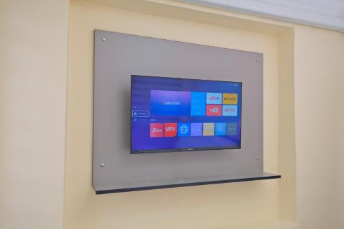 a flat screen tv on a wall at Lucky Hotel İstanbul in Istanbul